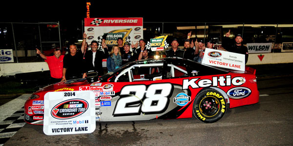 Donald Chisholm celebrates winning the Wilson Equipment 300 with his Nova Racing crew (photo - Ken MacIsaac)